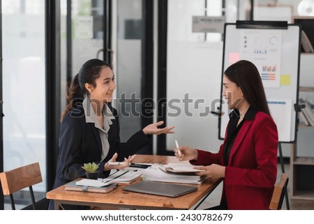 Young beautiful Asian businesswomen working together in the modern office room.