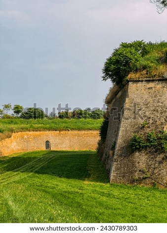 Park with green hills and historical architecture at the Petrovaradin Fortress, Novi Sad, Serbia. High quality photo