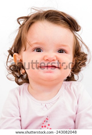 Photo of an adorable baby girl looking at the camera