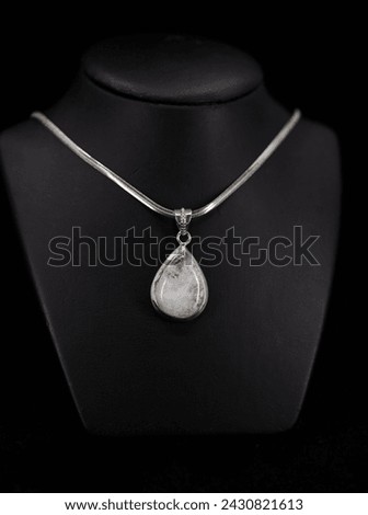 Silver necklace, jewelry accessories silver pendant. Selective focus, noise effect. Royalty-Free Stock Photo #2430821613