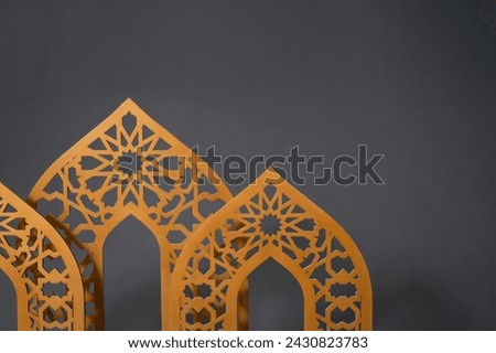 Selected focus photo of a golden dome-shaped Islamic ornament made of wood with a blurred background