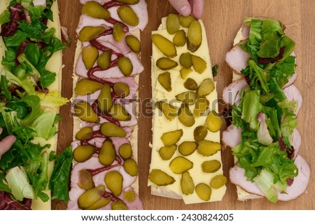Make colorful baguette sandwiches with ham, cheese, lettuce and cucumber