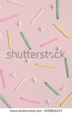 Colorful candles for birthday party in pattern on pink background. Happy birthday creative concept.