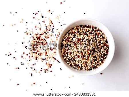 Organic Tri-Color Quinoa in a White Ceramic Bowl. Healthy Eating Concept. Top view. Royalty-Free Stock Photo #2430831331
