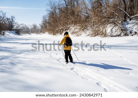 Winter sport, man skiing in the snow, walking in the park among the trees, trekking alone in the harsh conditions of winter. High quality photo Royalty-Free Stock Photo #2430842971
