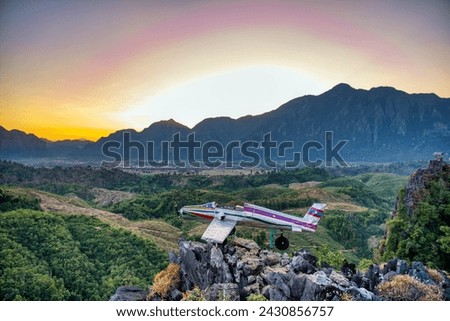 Sunrise in Vang Vieng at Phapoungkham viewpoint. Airplane on the top of the mountain, Sunset time, sun goes down, amazing view. High quality photo Royalty-Free Stock Photo #2430856757