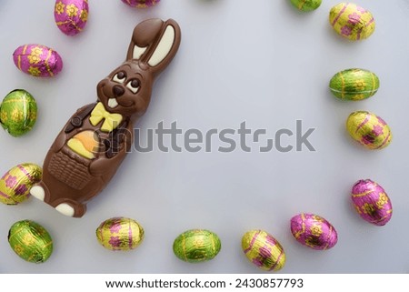 
Bunny and chocolate easter eggs on white background.