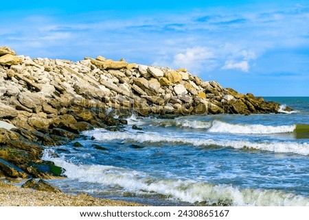 Rocky shore in selective focus, sea ​​water. Sea wave out of focus. Sea coast, vacation, rest.Dagestan, Makhachkala.