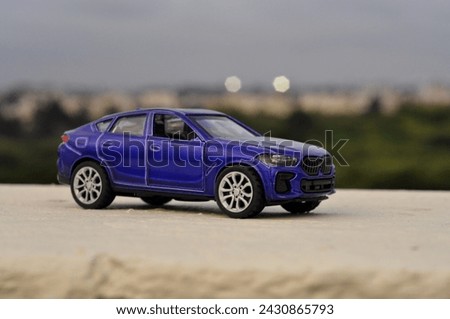 Purple toy car photography with nature background, Toy car