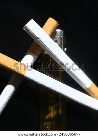 Cigreete picture with yellow lighter and black background 