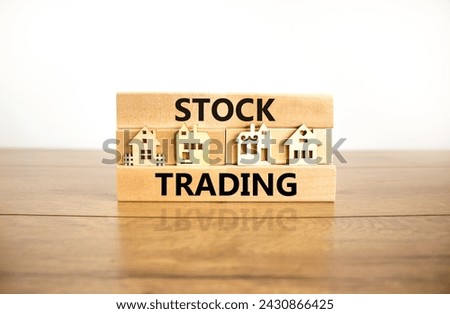 Stock trading symbol. Concept words Stock trading on beautiful wooden blocks. Beautiful wooden table white background. House model. Business stock trading concept. Copy space.