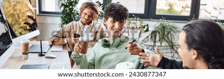 Young men smiling together during coffee break at a startup office, post production team banner