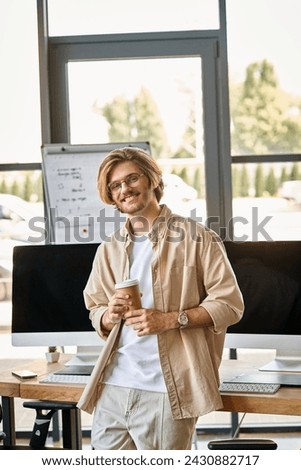 Smiling professional with glasses holding coffee in modern office setup, post production team