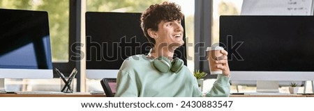 happy young man with headphones sitting in office chair and holding coffee, post production banner