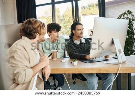 Creative team intensely focused on post-production work in a modern office, men in 20s
