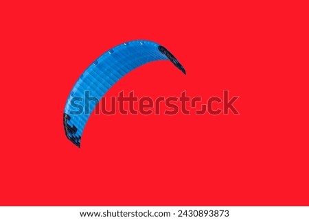 The parachute is a wing on a red background.                               