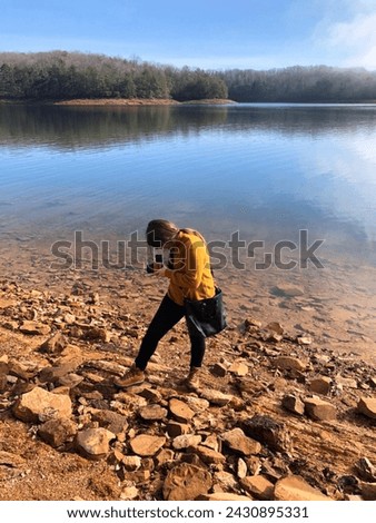 Woman photographs fall on the lake with her medium format film camera
