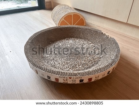 focus on Round Cat Scratcher made of corrugated paper , place on the floor in the living room Royalty-Free Stock Photo #2430898805