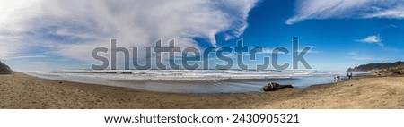 Tropical ocean beach with ocean waves and blue skies and clouds in panoramic format. No data Licensing. Royalty-Free Stock Photo #2430905321