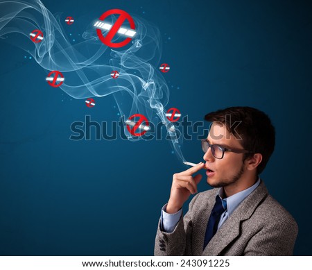 Attractive young man smoking dangerous cigarette with no smoking signs