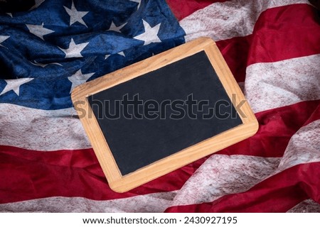 Empty Slate board with copy space onto USA flag in background.
