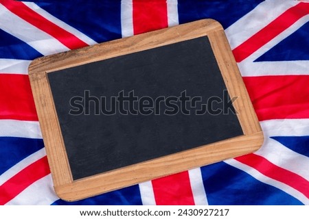 Wooden Slate on United Kingdom flag in background with copy space.