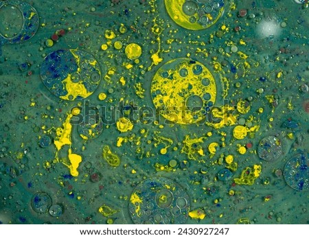 Green background and yellow spots making abstract art wallpaper.