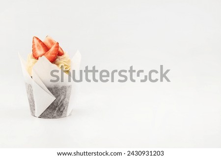 Cupcake with strawberries on a white background with space for writing text.