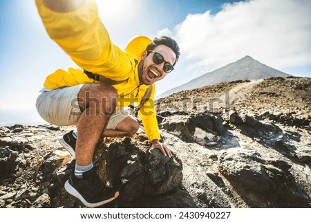 Happy hiker having fun hiking mountains - Active young man taking selfie pic with smart mobile phone device outdoors - Action cam, extreme sports and summertime holidays concept Royalty-Free Stock Photo #2430940227