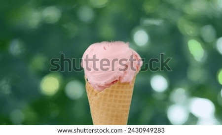 Summer Bliss and Indulging in a Delicious Strawberry Ice Cream Cone Held Lovingly in Hand