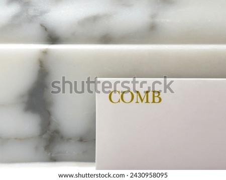 Envelope with a complimentary comb in a high end luxury hotel with the word, text comb.