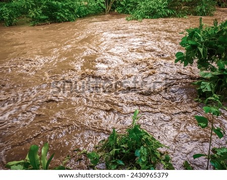 River water is dirty and brown due to flooding during the rainy season, rainy season flooding, river water overflowing