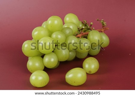 Red apple isolated clipping path, full depth of field.Green grape with leaves isolated With clipping path. 