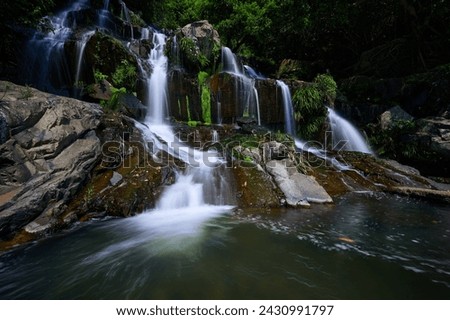 A waterfall with rock and moss