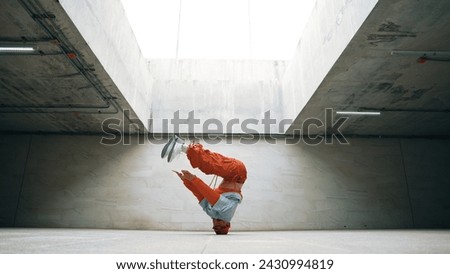 Happy dancing man enjoy practice break dance or freestyle dance in building. Professional b-boy dancer perform energetic movement or doing freeze pose modern life style. Outdoor sport 2024. Sprightly. Royalty-Free Stock Photo #2430994819