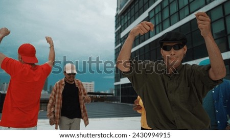 Caucasian hipster walking while dancing together at rooftop with city view. Multicultural dancer practicing street dance at cityscape or sky scrapper. Street dancing. Outdoor sport 2024. Endeavor.