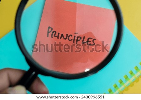 Concept of Principles write on sticky notes isolated on Wooden Table.