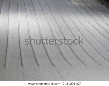 a photography of a person riding a snowboard down a snow covered slope.