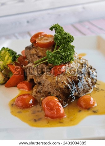 GRILLED HAMOUR Fish with gravy, broccoli and tomato served in dish isolated on table closeup top view of grilled seafood