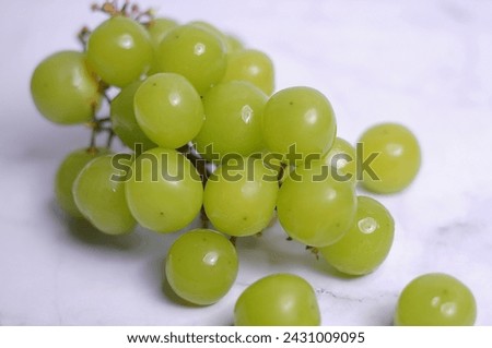 bunch of ripe and juicy green grapes close-up on a white background