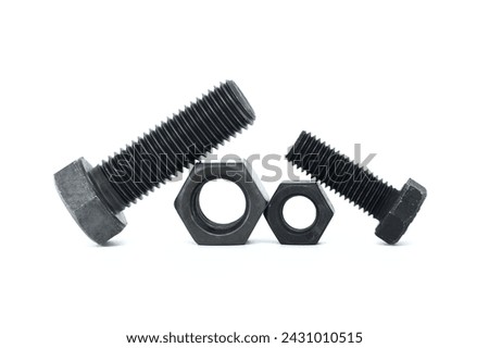 Orderly arrangement of dark-colored metal of hex bolts and nuts include long and shorter parts, placed against a clean, white background Royalty-Free Stock Photo #2431010515