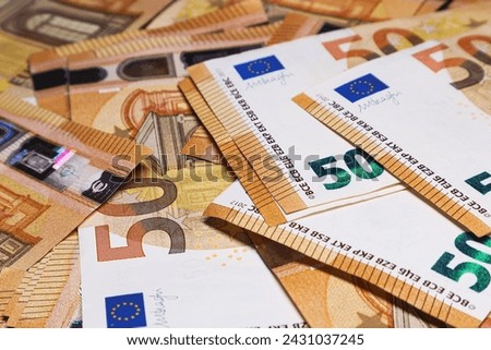 Money background, surface covered with 50 euro banknotes close-up. Soft focus.