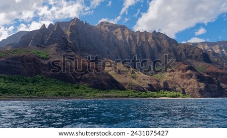View from a tourist boat at stunning coast in the Napali Coast State Wilderness Park, Island of Kauai, Hawaii
