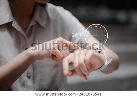 nonstop service concept. businessman hand holding virtual 24-7 with clock on hand for smart phone nonstop and full-time available contact of service concept. customer service. Royalty-Free Stock Photo #2431075541