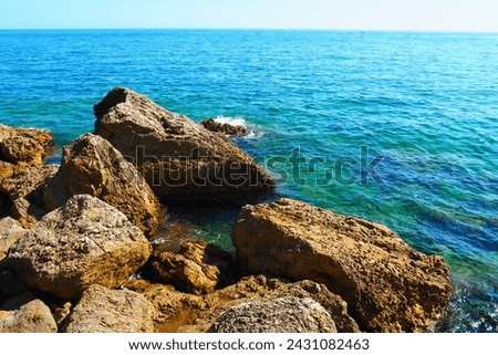 Flysch is a series of marine sedimentary rocks that are predominantly clastic in origin and are characterized by alternation of lithological layers. Balkans, Montenegro, Budva, Mogren beach. The sea Royalty-Free Stock Photo #2431082463