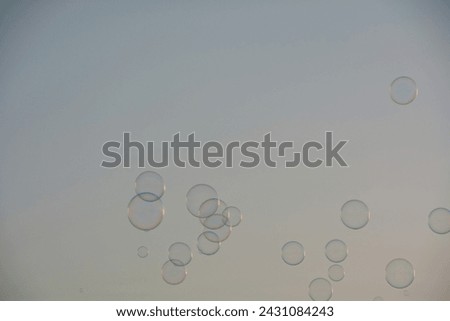 Many colorful soap bubbles float in the sky