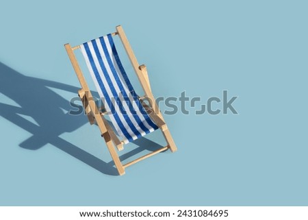 Chaise longue, beach chair, seaside relaxation, vacation getaway, blue background