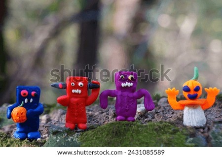 Gnome figurines decorated with pumpkin and zombies. Halloween decorations.