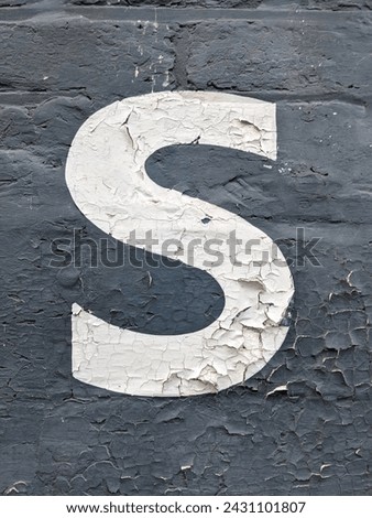 A Written Wording in Distressed State Typography Found Number Letter S