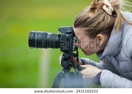 woman photographer looking into camera